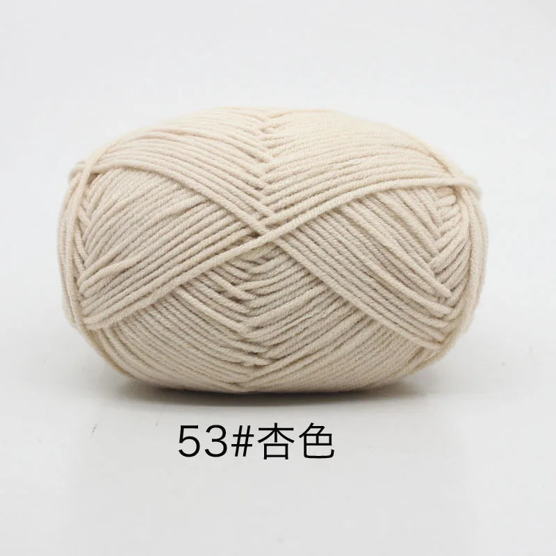 A ball of light beige 4-ply milk cotton yarn for knitting and crochet.