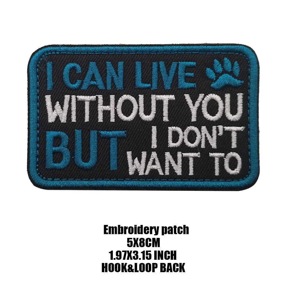 Black embroidered patch with white text that reads I CAN LIVE WITHOUT YOU BUT I DON'T WANT TO featuring a paw print design