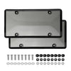 A set of two black tinted license plate protectors with various mounting hardware included.