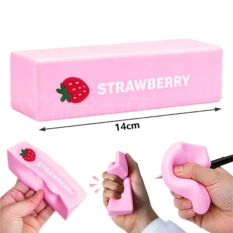 Pink strawberry shaped squishy butter fidget toy being squeezed by a hand