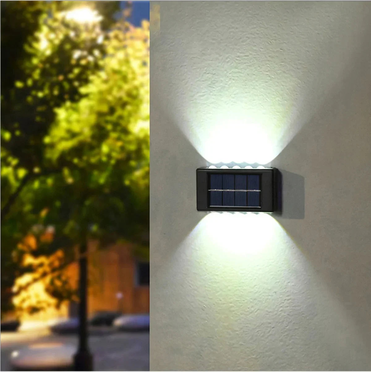 A solar powered wall light mounted on a white wall, casting illumination both up and down.