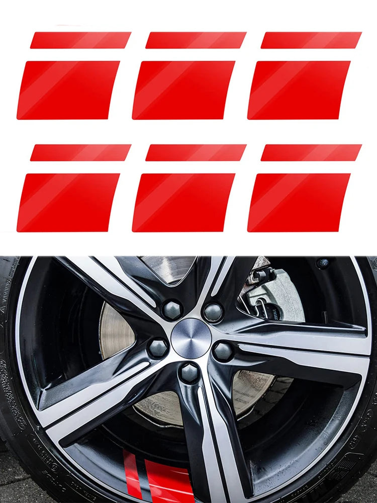 Red reflective safety stickers displayed above a close-up of a black car wheel.