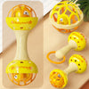 A set of yellow and orange baby sensory spinning rattle toys for infants.