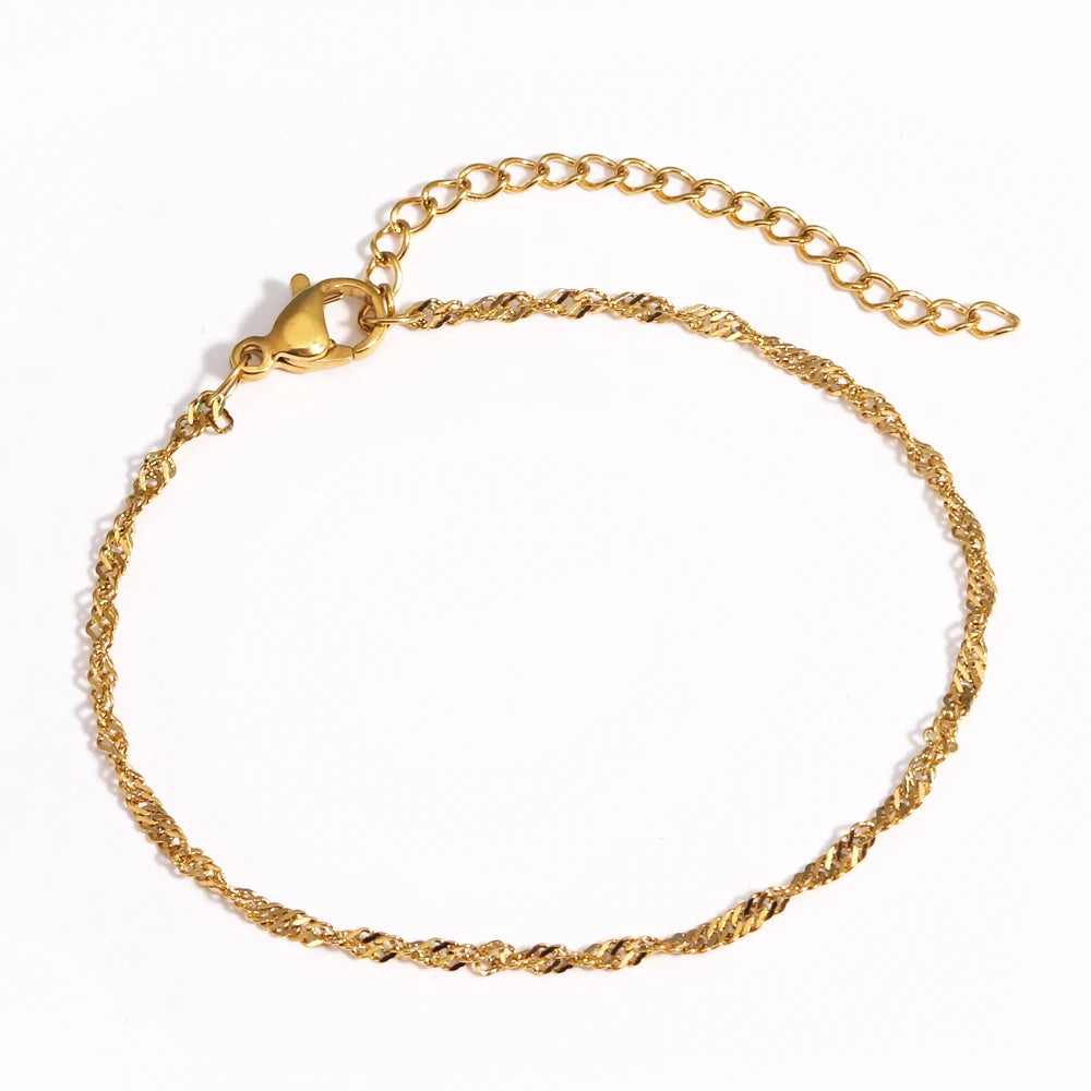 A gold-plated stainless steel link bracelet shown against a white background.