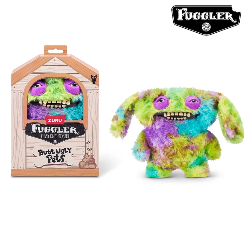 A green and purple Fuggler Ugly Monster plush toy with funny teeth is displayed next to its packaging box.