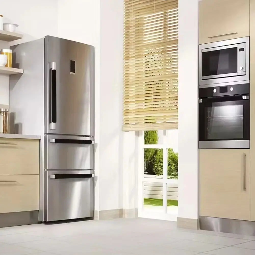 A stainless steel refrigerator with a light beige cabinet and a glass-fronted oven is shown in a kitchen setting.
