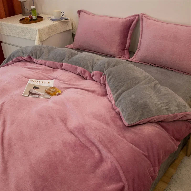 A pink flannel duvet cover with a gray zipper and matching pillows displayed on a bed.