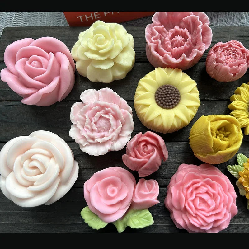 A collection of pink and yellow 3D rose peony silicone molds for crafting.