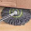 A gray rope of cleaning twine with a silver handle and green accents is shown on a wooden surface.