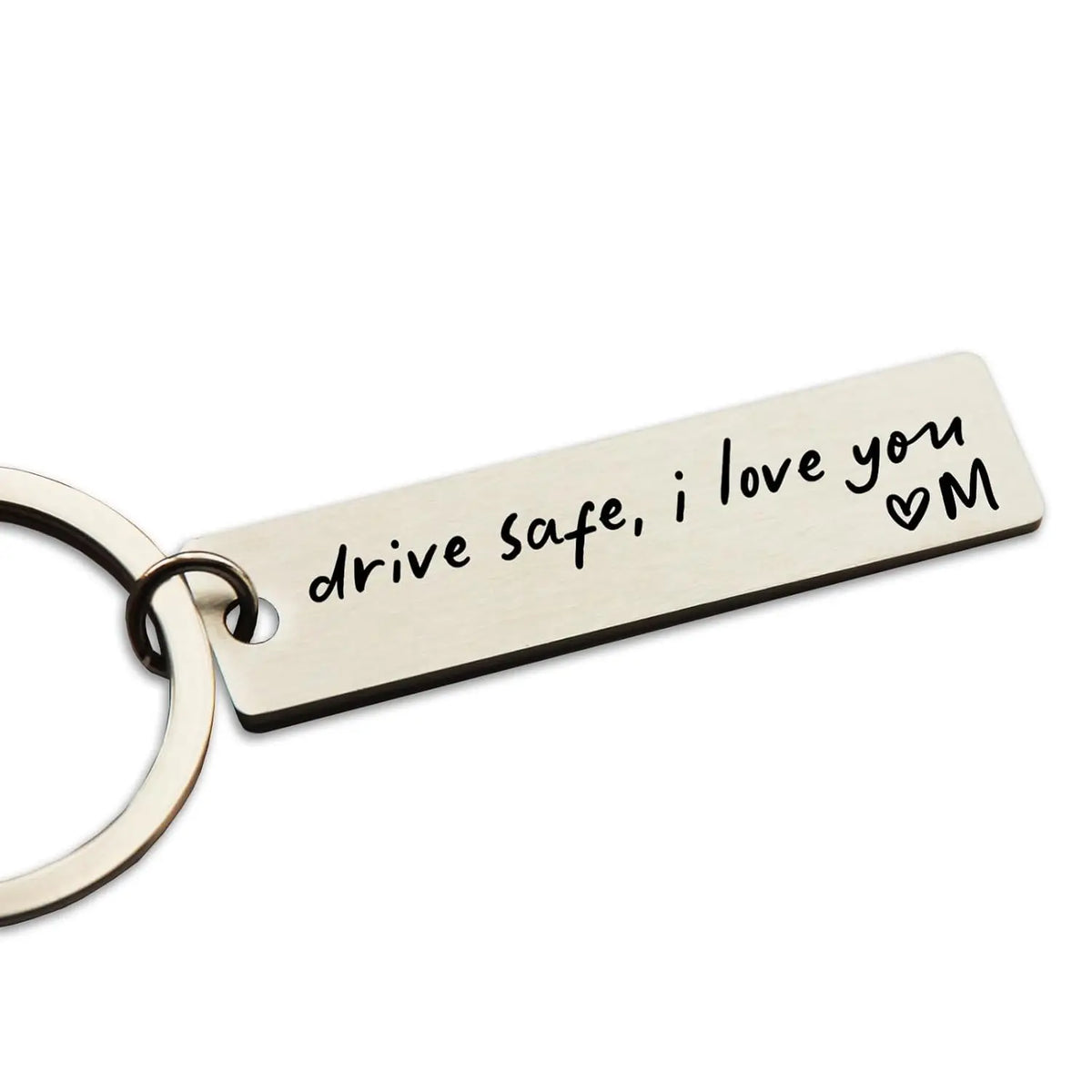 A personalized stainless steel keychain tag engraved with the message drive safe i love you and a heart M