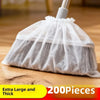 A white disposable broom cover made of sheer mesh fabric is shown on a wooden floor.