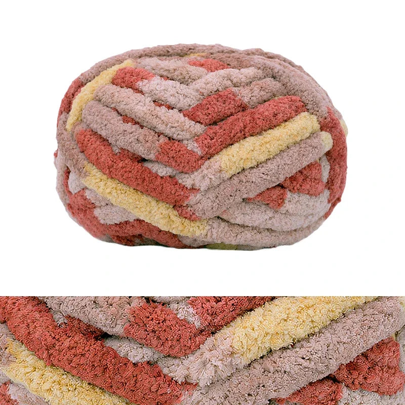 A ball of chunky chenille yarn featuring a textured pattern in shades of pink, orange, and beige.