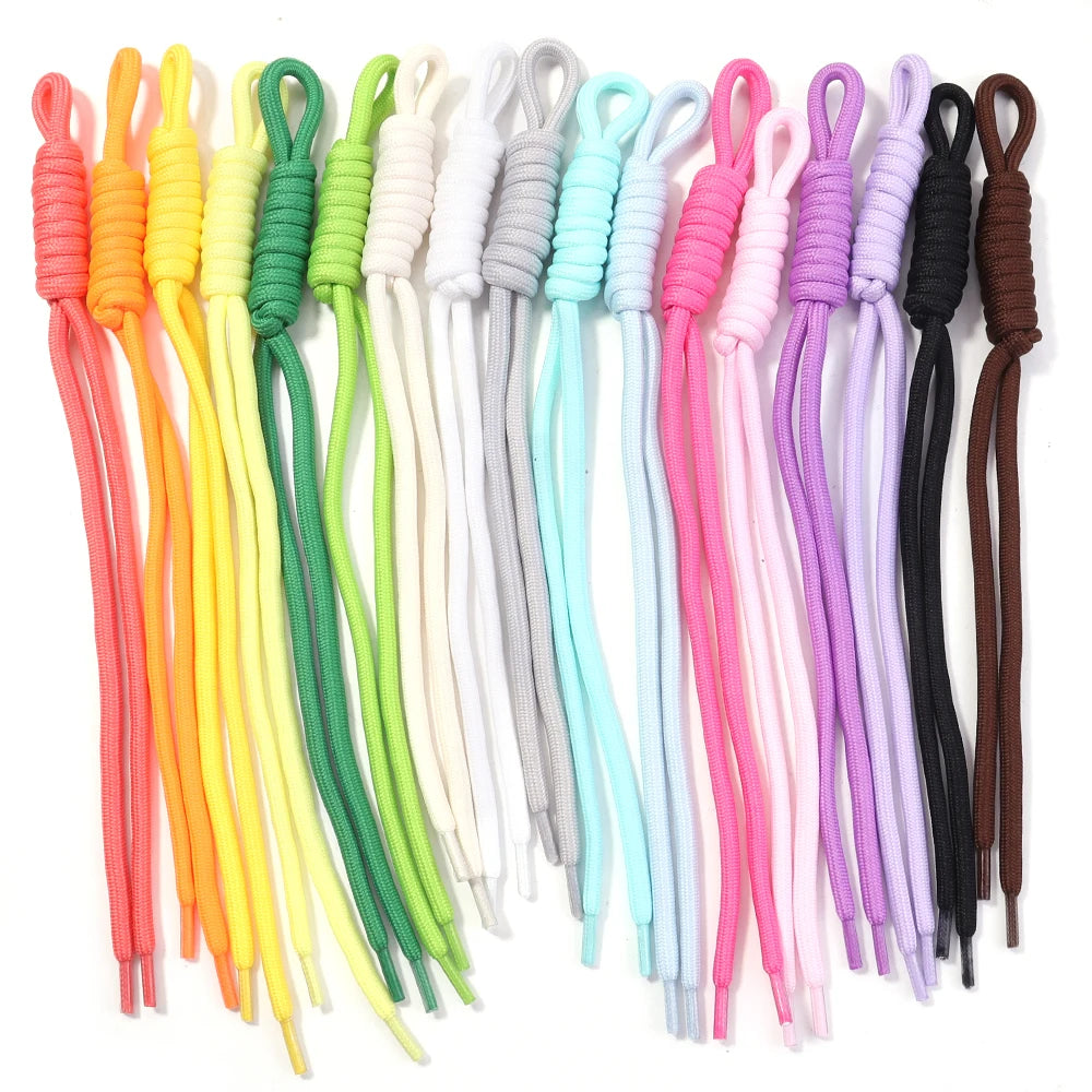 A variety of colorful braided nylon lanyards in various shades including orange, yellow, green, pink, and purple.