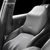 A memory foam car headrest and lumbar support pillow shown installed in a car seat, demonstrating its ability to be leaned ba