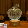 A white wireframe apple 3D illusion LED night light lamp sitting on a wooden table.
