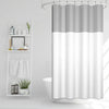 A waffle weave shower curtain with a geometric stripe pattern hanging in a bathroom.
