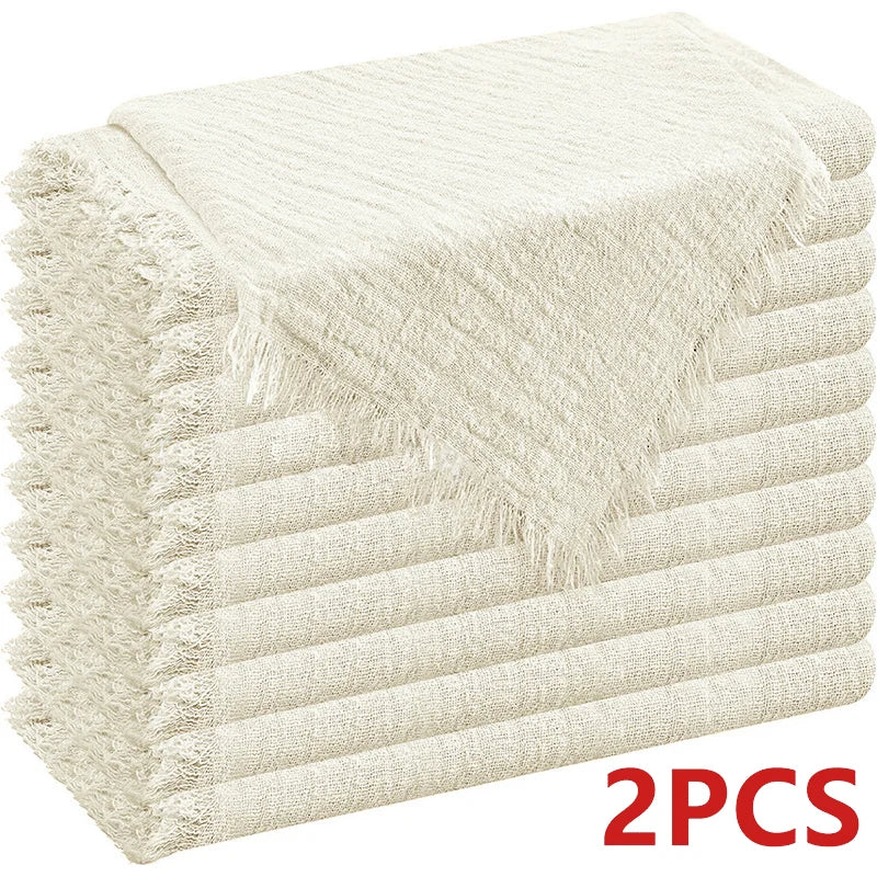 A stack of six beige raw-edge polyester cloth napkins folded neatly.