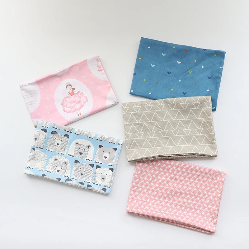 A collection of soft cotton baby pillowcases featuring various cartoon designs and patterns in pink, blue, and beige.
