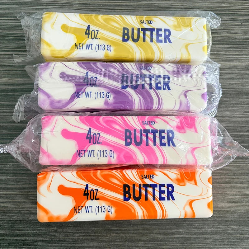 Four different salted butter scented fidget sticks in yellow, purple, pink, and orange swirls.