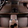 Interior view of a car showing waterproof leather floor mats and controls.