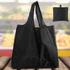 A black foldable reusable grocery bag is shown against a blurred background of groceries.