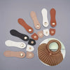 A set of eight leather buckle clasps in various shades of tan and beige are displayed on a gray background.