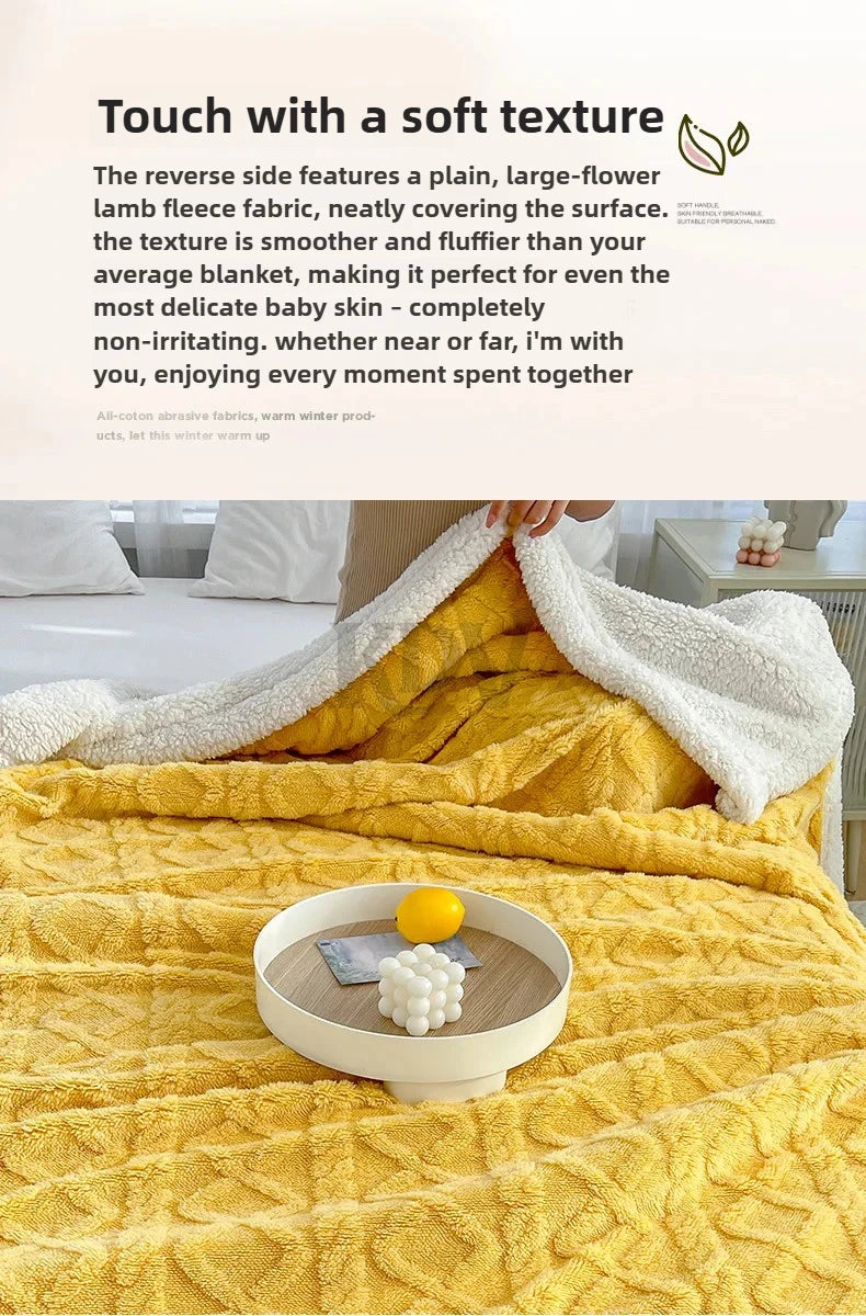 A yellow fleece throw blanket is draped over a bed, with a white fleece blanket folded beside it.