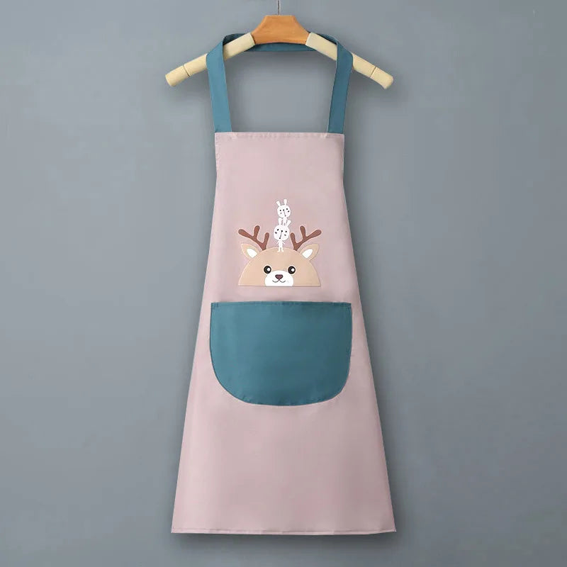 A light pink waterproof kitchen apron with a teal pocket and a deer face design is hanging on a wooden hanger.
