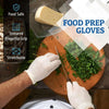 A hand wearing a white nitrile glove is using a knife to chop fresh green herbs on a wooden cutting board.