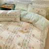 Pink floral bedding set featuring a duvet cover and pillowcases with delicate patterns.