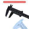 A plastic vernier caliper tool showing a scale for accurate measurement.