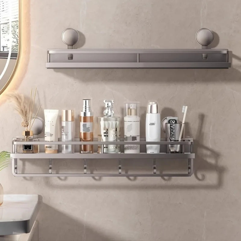 A silver wall-mounted shower caddy with suction cups holds various toiletries and grooming products.