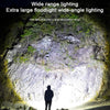 A flashlight illuminating a natural rock formation and surrounding vegetation.