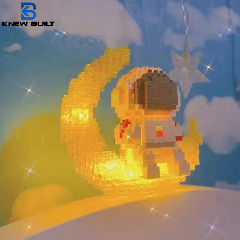 A luminous building block set shaped like an astronaut and a crescent moon, illuminated with warm yellow light.