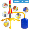 Installation guide showing the assembly of a yellow and red stepping rocket launcher toy set for kids