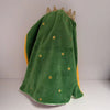 A plush toy of Jesus in green fabric with gold stars and a golden crown.