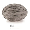 A ball of gray extra thick chenille yarn used for hand knitting projects.