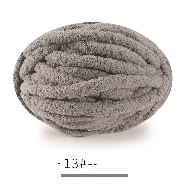 A ball of gray extra thick chenille yarn used for hand knitting projects.