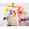 A colorful arrangement of 3D cartoon animal balloons in various shades of pink, yellow, green, and red for party decorations.