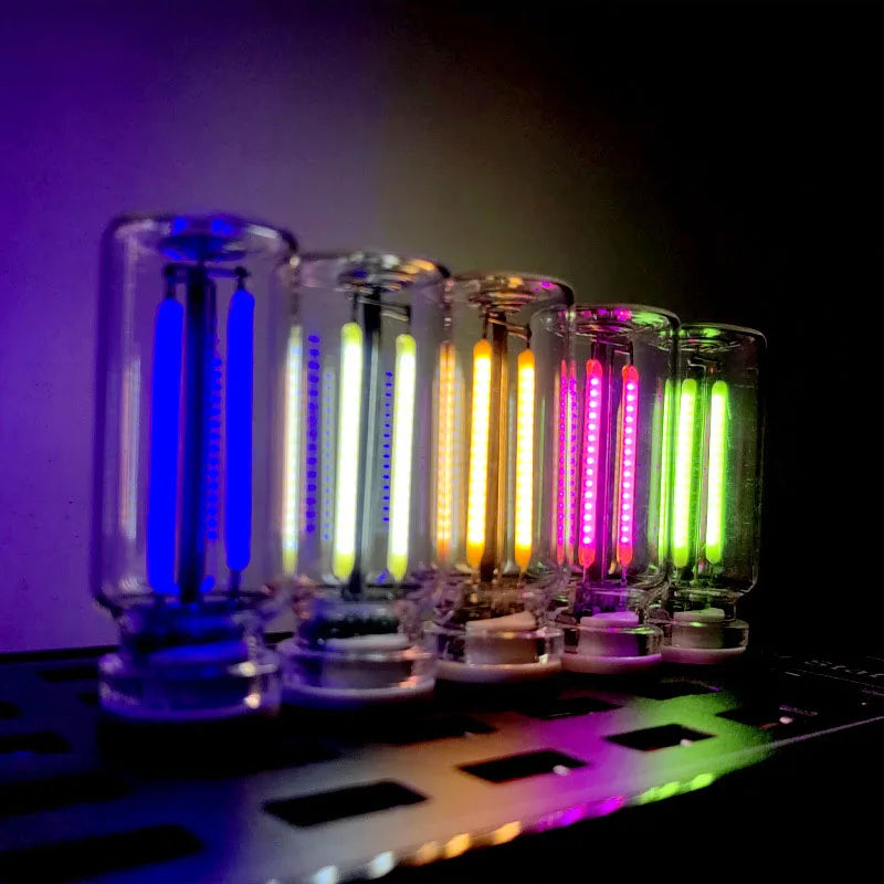 A row of glass tubes displaying various colors of warm filament glow lights on a dark surface.