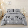 Gray duvet cover set featuring a butterfly print on a bed with white wall paneling.