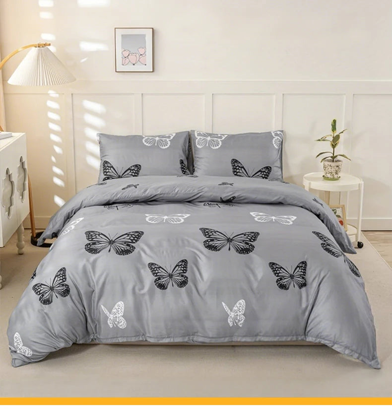 Gray duvet cover set featuring a butterfly print on a bed with white wall paneling.