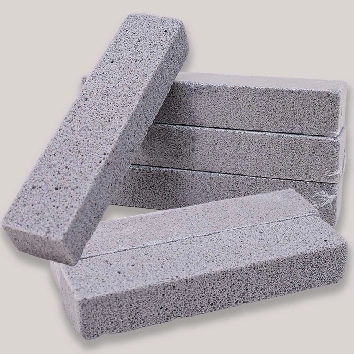 Stack of gray foam glass pumice stone cleaning brushes for toilets and sinks