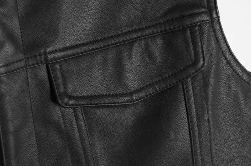 Close-up of a black faux leather biker vest showing stitching and a flap pocket detail.