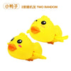 A pair of yellow cartoon duck toys, part of a two random set.