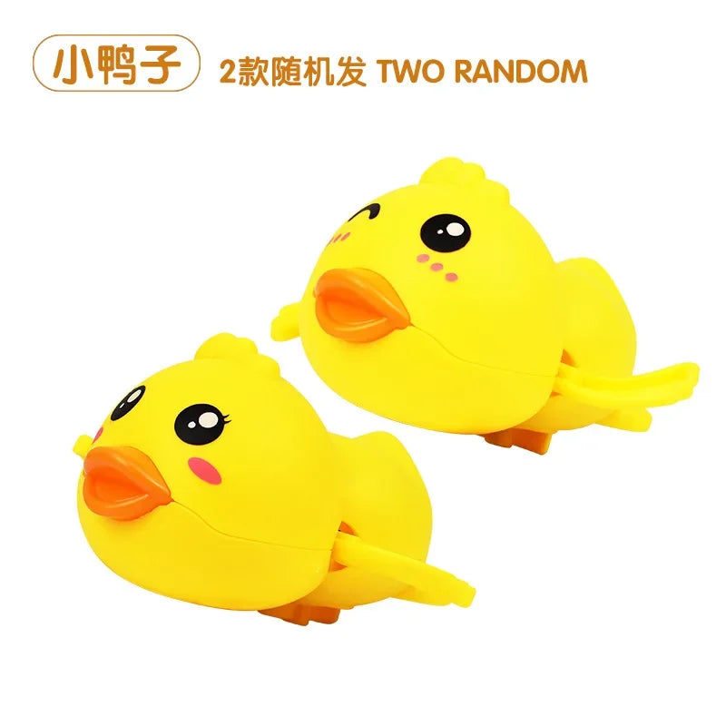 A pair of yellow cartoon duck toys, part of a two random set.