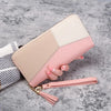 A light pink and beige long zip-around PU leather wallet with card slots is shown against a gray background.