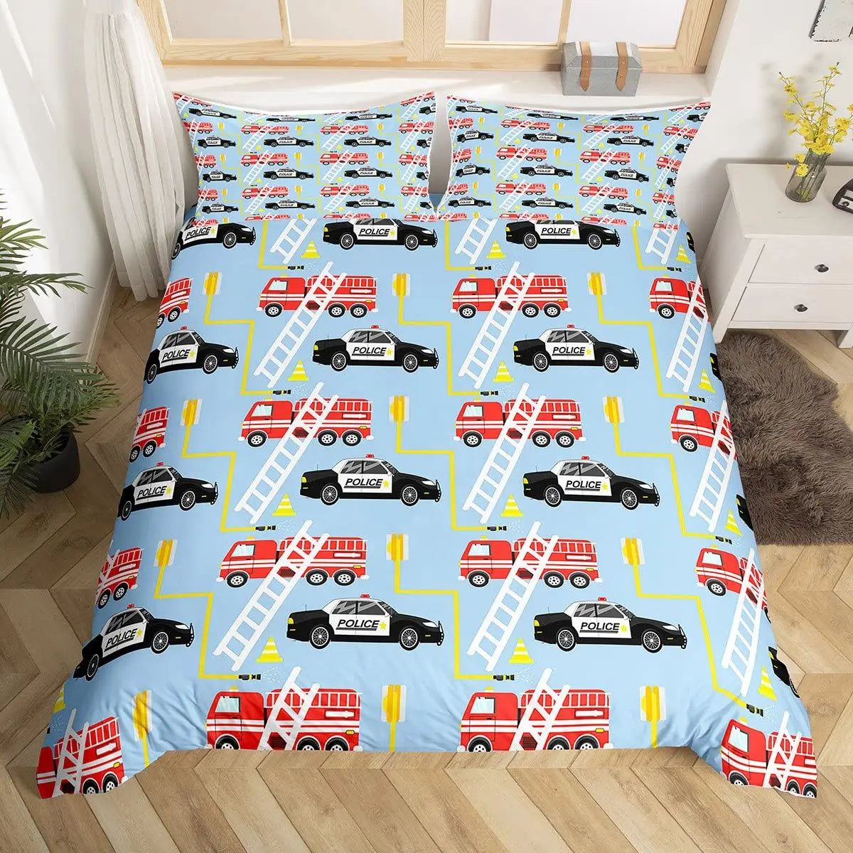 A blue duvet cover set featuring a repeating pattern of police cars and fire engines on a light blue background.