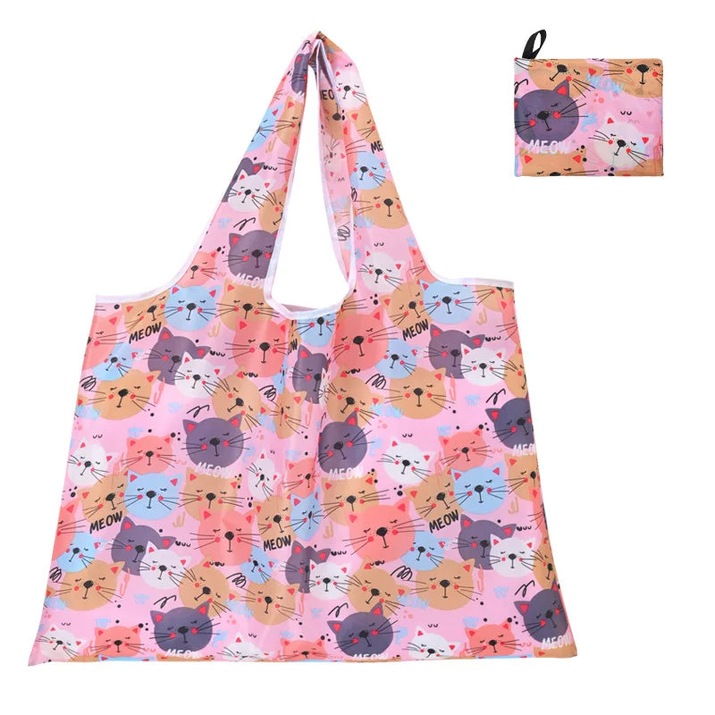 A pink and purple patterned reusable shopping tote bag with a matching small carry pouch.