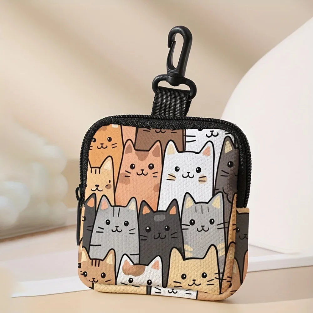 A black mini coin purse featuring a collage of various cat faces in shades of orange, gray, and white.